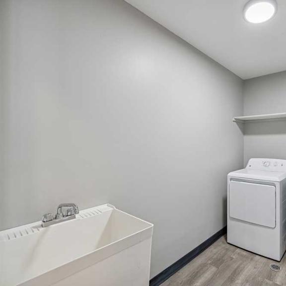 Thumbnail 33 of 79 A laundry room with a washer and dryer.
