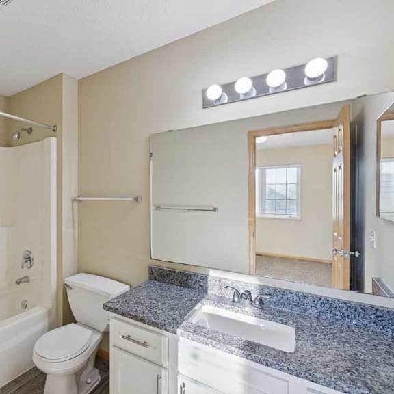 Thumbnail 61 of 79 A bathroom with a white toilet, sink, and bathtub.