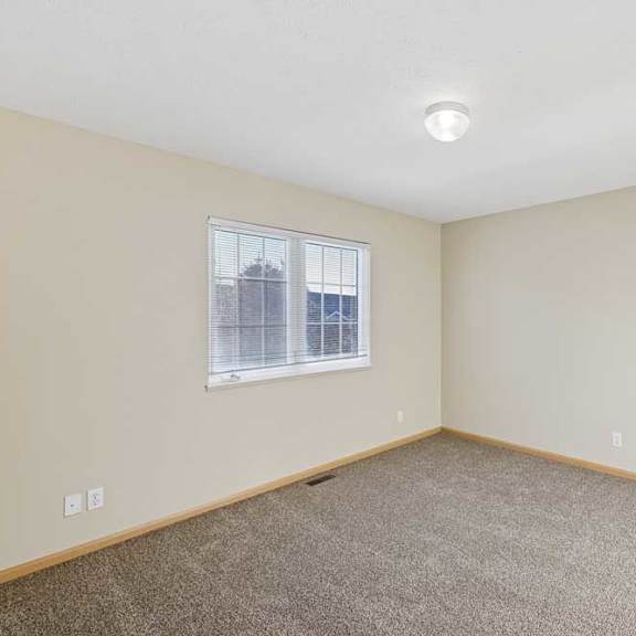 Thumbnail 68 of 79 A room with a window and carpeted floor.