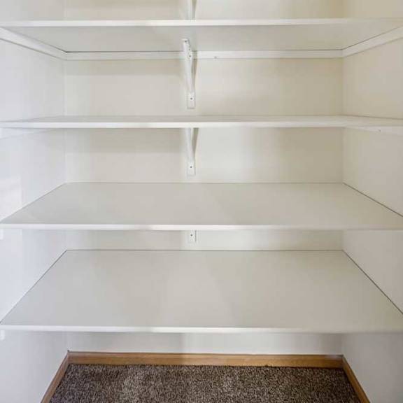 Thumbnail 78 of 79 Empty white shelves in a room.