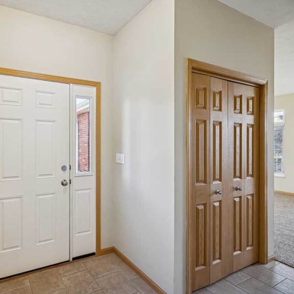 Thumbnail 66 of 79 A white door with a window above it and a brown door to the right.