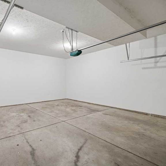 Thumbnail 63 of 79 A room with a white wall and a concrete floor.