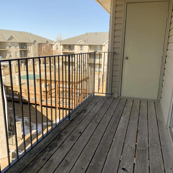 Thumbnail 12 of 22 balcony overlooking community swimming pool at Eagle Run Apartments in Omaha Nebraska