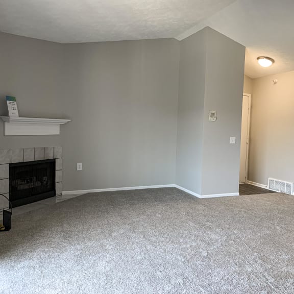 Thumbnail 5 of 22 Spacious living room with cozy fireplace at Eagle Run Apartments in Omaha Nebraska
