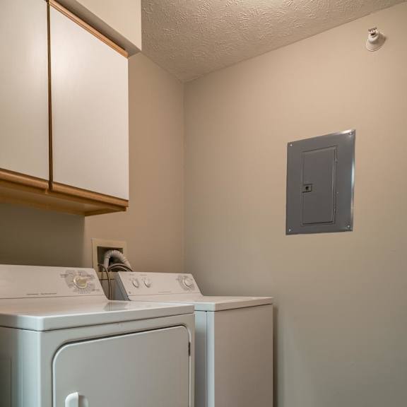 Thumbnail 15 of 22 A white washer and dryer in a small laundry area.