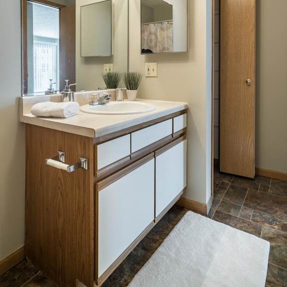 Thumbnail 22 of 22 A bathroom with a sink, mirror, and lighting fixture.