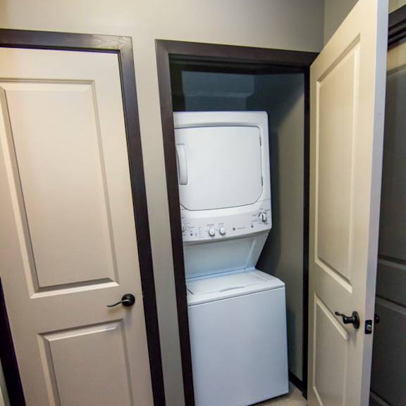 Thumbnail 10 of 13 Hall closet with stacked washer and dryer unit
