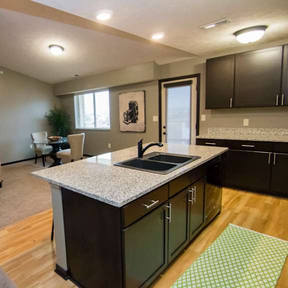 Thumbnail 4 of 13 A kitchen with a white sofa and a countertop.