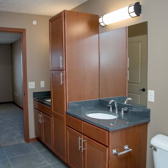 Thumbnail 10 of 15 A bathroom with a sink, toilet, and medicine cabinet.
