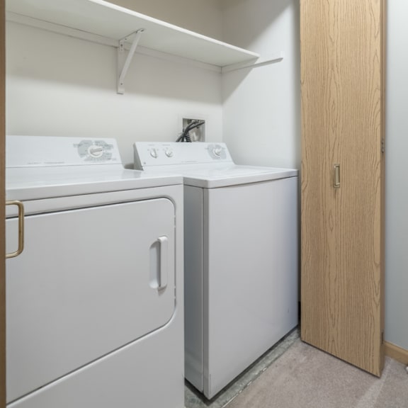 Thumbnail 8 of 9 a full size washer and dryer in a double door closet with overhead storage