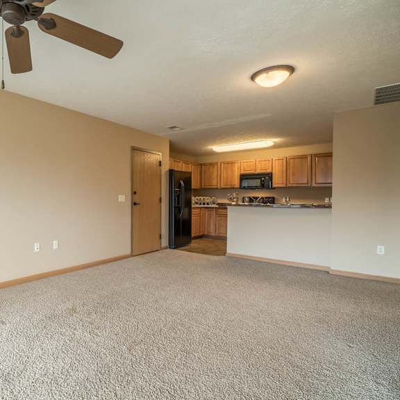 Thumbnail 4 of 12 a empty living room with a ceiling fan