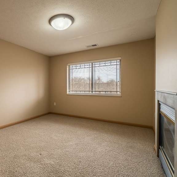 Thumbnail 8 of 12 an empty bedroom with a window and carpet