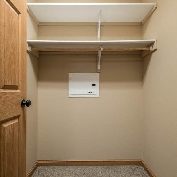 Thumbnail 10 of 12 a empty closet with a door and a paper towel dispenser