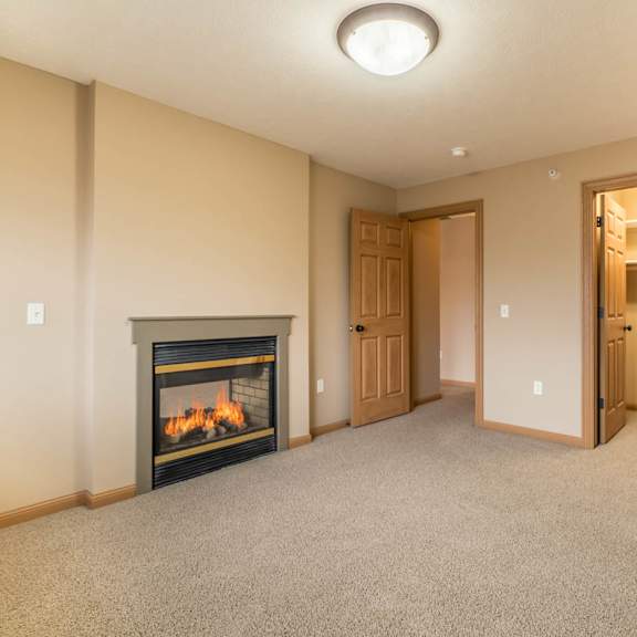 Thumbnail 9 of 12 an empty bedroom with a fireplace