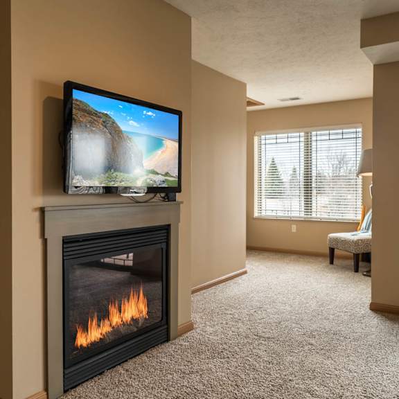 Thumbnail 8 of 17 a living room with a fireplace and a tv