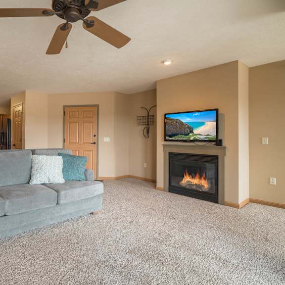 Thumbnail 6 of 17 a living room with a couch and a fireplace