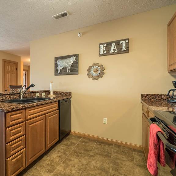 Thumbnail 4 of 17 a kitchen with a sink and a counter top