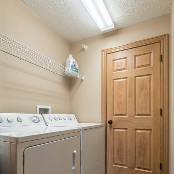 Thumbnail 11 of 17 a washer and dryer in a laundry room with a door
