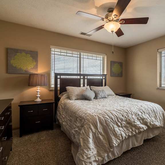 Thumbnail 14 of 17 a bedroom with a bed and a ceiling fan