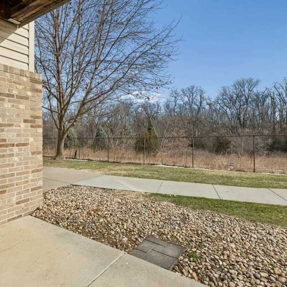 Thumbnail 19 of 19 Patio area overlooking landscaped grounds and fenced green space