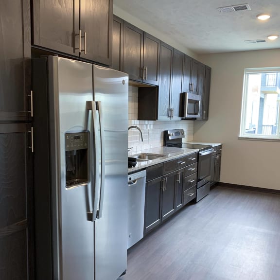 Thumbnail 3 of 18 Kitchen with natural lighting and matching stainless steel appliances