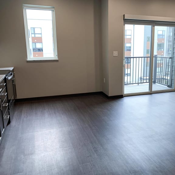 Thumbnail 6 of 18 Open kitchen into dining room with sliding door leading to deck at Haven at Uptown