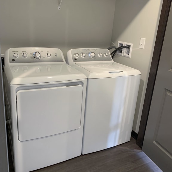 Thumbnail 18 of 18 Full sized washer and dryer with rod and shelf above for storage at Haven at Uptown