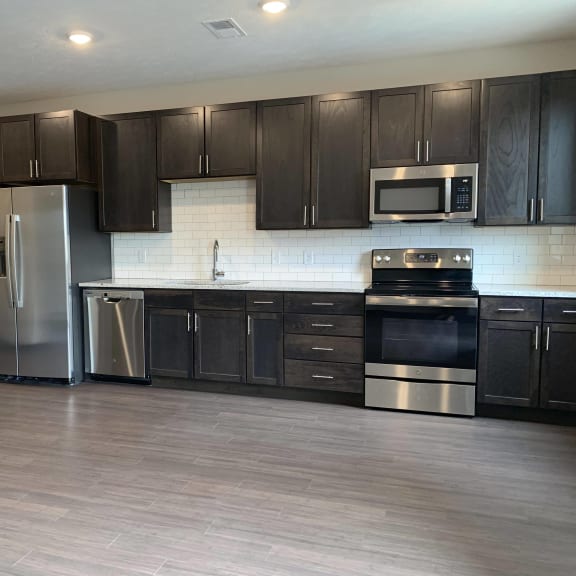 Thumbnail 4 of 18 Open kitchen with matching stainless steel appliances in Peace floorplan at Haven at Uptown