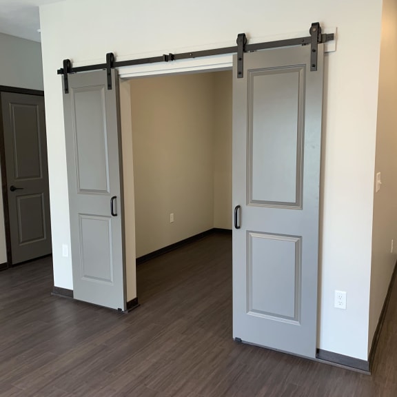 Thumbnail 10 of 18 Den or office space with elegant double barn doors at Haven at Uptown