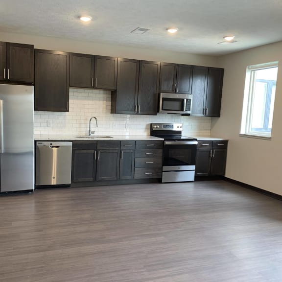 Thumbnail 5 of 18 Open kitchen into living and dining area at Haven at Uptown