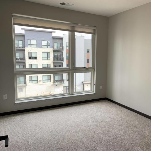 Thumbnail 11 of 18 Spacious bedroom with large windows and a lot of natural light in the peace floorplan at Haven at Uptown
