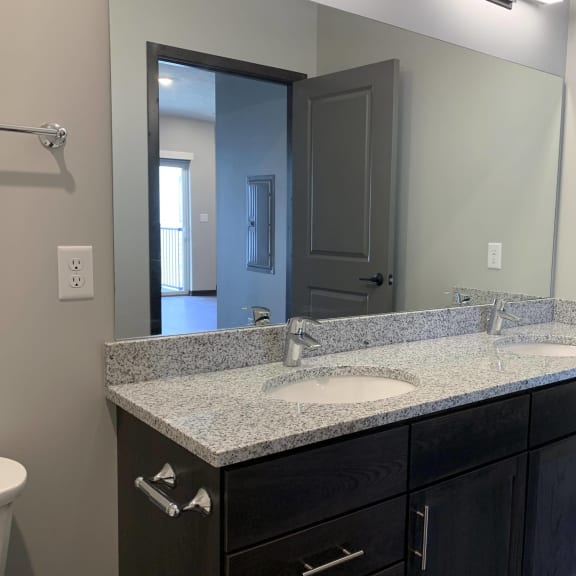 Thumbnail 15 of 18 Bathroom with dark brown double vanity with storage and large mirror