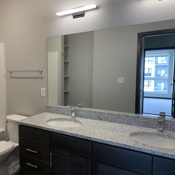 Thumbnail 16 of 18 Spacious bathroom with double vanity and shower tub combo
