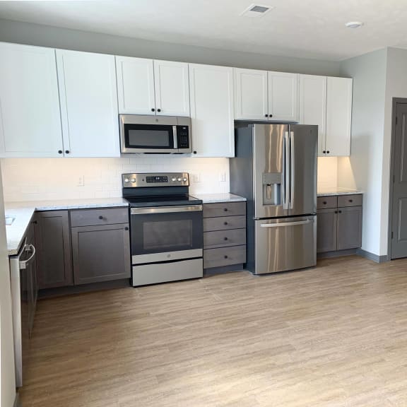 Thumbnail 3 of 17 Spacious open kitchen with matching steel appliances and under cabinet lighting in serenity floorplan at Haven at Uptown