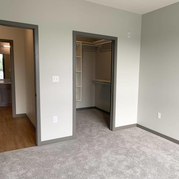 Thumbnail 12 of 17 Bed room with large walk in closet with shelving