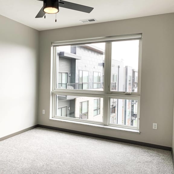 Thumbnail 11 of 17 Carpeted bedroom with large floor to ceiling window