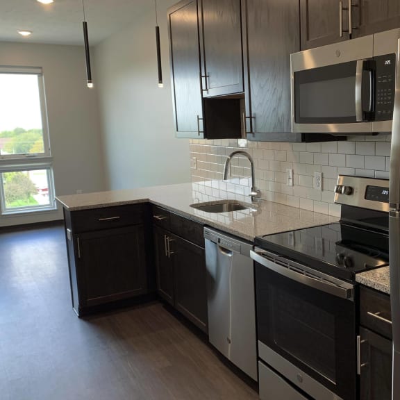 Thumbnail 5 of 12 Kitchen with matching stainless steel appliances in Zen floorplan at Haven at Uptown