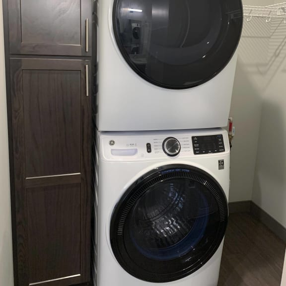 Thumbnail 12 of 12 Stacked full size front load washer and dryer with linen storage in apartment in Lincoln