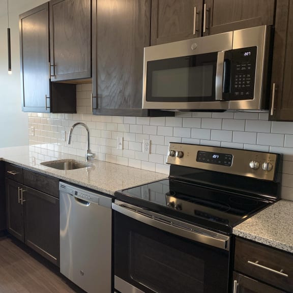 Thumbnail 3 of 12 Kitchen with matching stainless steel appliances in Zen floorplan at Haven at Uptown
