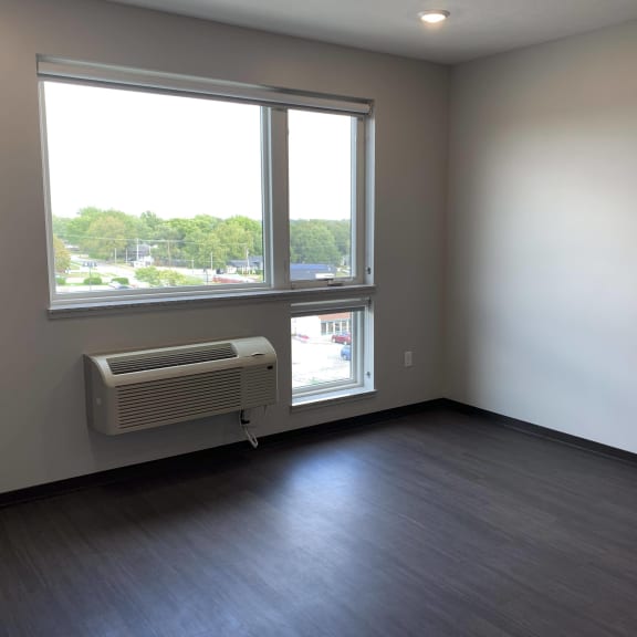 Thumbnail 8 of 12 Living area with dark wood style floors with large windows and city view