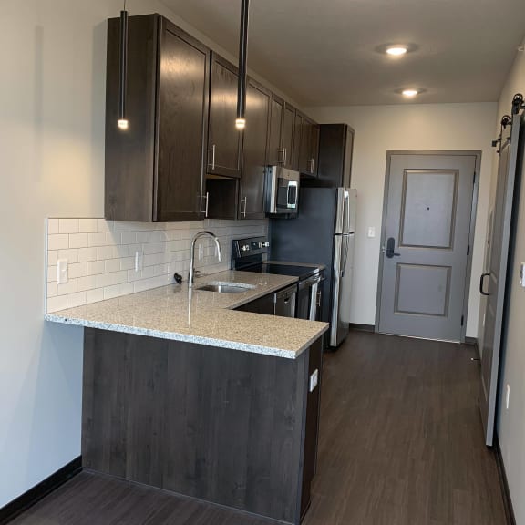 Thumbnail 7 of 12 Large L-shaped granite countertop in Zen floorplan at Haven at Uptown
