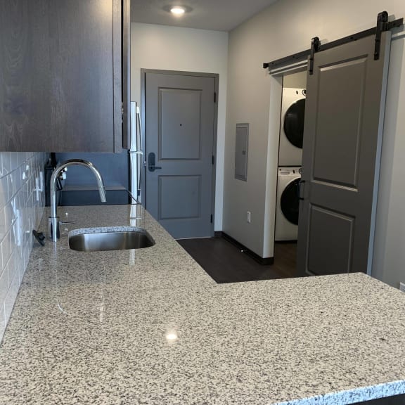 Thumbnail 6 of 12 Large L-shaped granite countertop in Zen floorplan at Haven at Uptown
