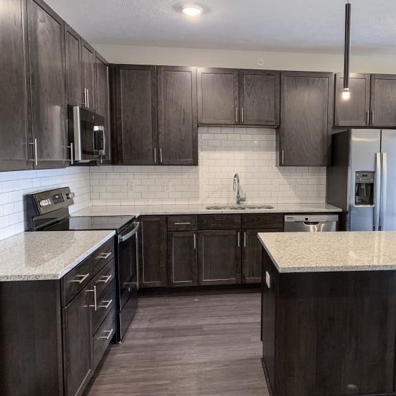 Thumbnail 5 of 15 kitchen with lots of storage cabinets in a warm mocha finish at Haven at Uptown