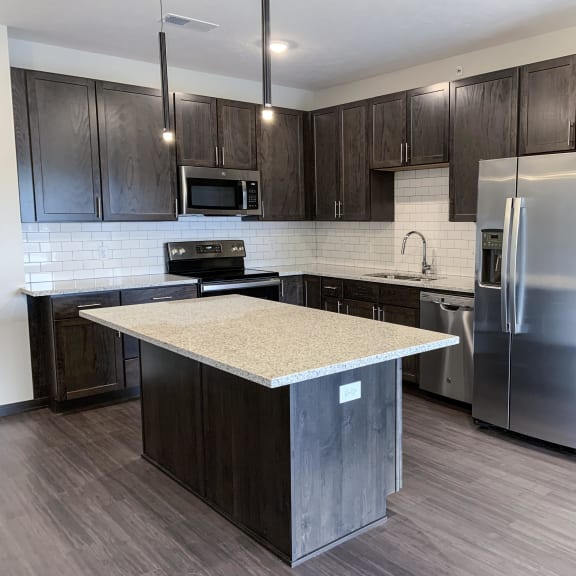 Thumbnail 2 of 15 kitchen with lots of storage cabinets in a warm mocha finish at Haven at Uptown