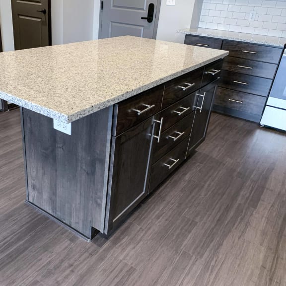 Thumbnail 4 of 15 Kitchen island with light granite counters, warm mocha cabinets and storage