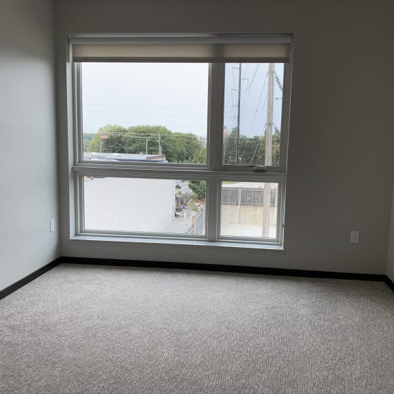Thumbnail 9 of 15 Open bedroom with large floor to ceiling window looking outside to north Lincoln