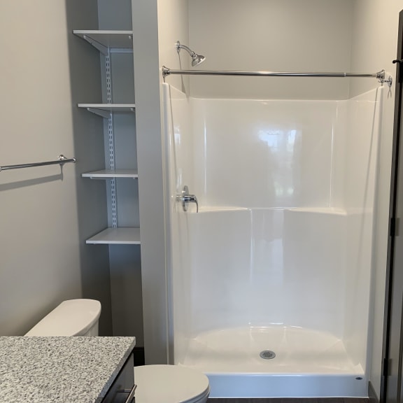 Thumbnail 15 of 15 bathroom with warm brown cabinets and lots of cabinet and linen storage