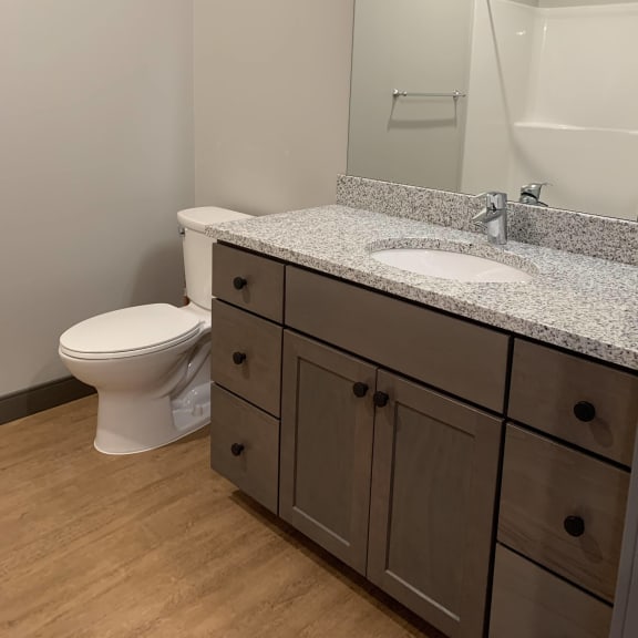 Thumbnail 10 of 11 Bathroom with light brown cabinetry and granite counter tops