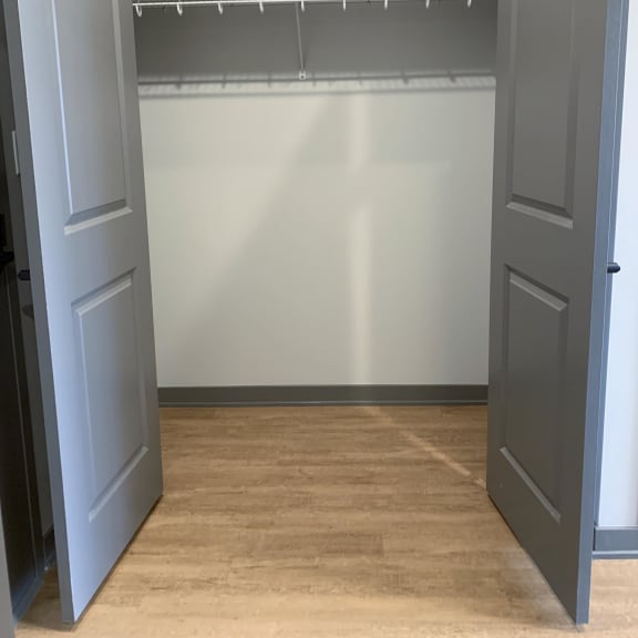 Thumbnail 5 of 11 Empty hall closet with bifold doors
