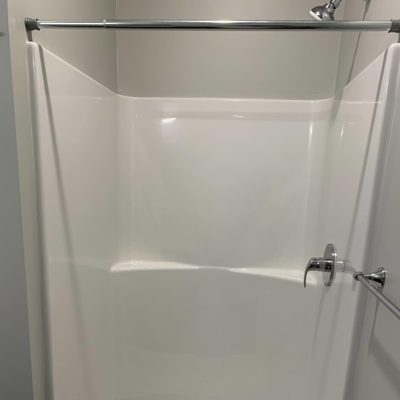 Thumbnail 22 of 23 Walk in shower with curtain rod in a studio floor plan at Haven at Uptown